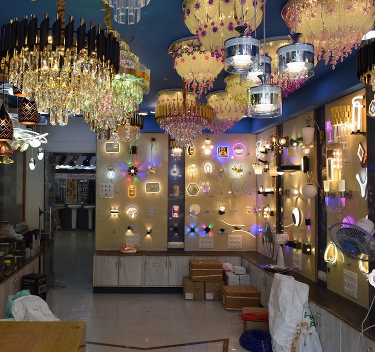 Crystal and gold chandeliers filling the blue ceiling above a wall of lit decorative fixtures and wall lights