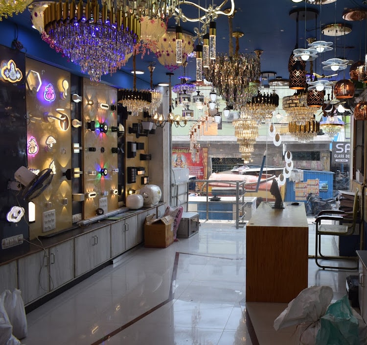 Decorative lighting hall with chandeliers overhead and illuminated LED wall panels down the left side