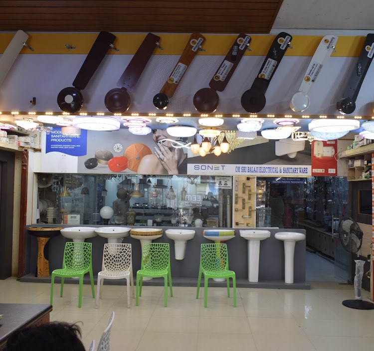 Main counter with ceiling fans and LED panels mounted overhead and a row of pedestal basins along the front