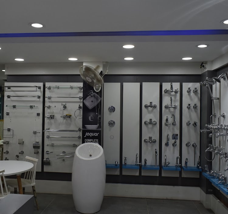 Jaquar bath fittings wall — towel rails and rods on the left, taps, mixers and showers on the panels to the right