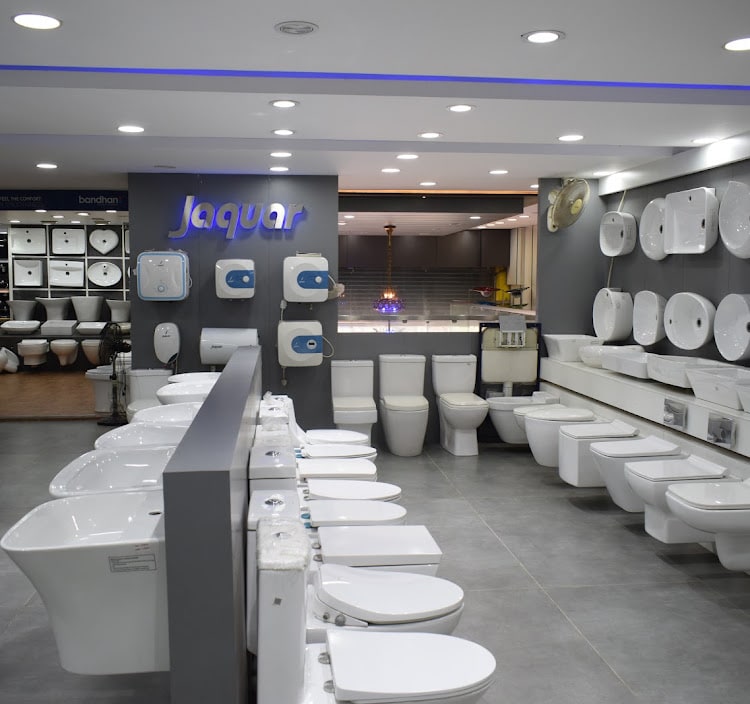 Jaquar section with water heaters on the pillar, water closets in double rows and wall-mounted basins along the right