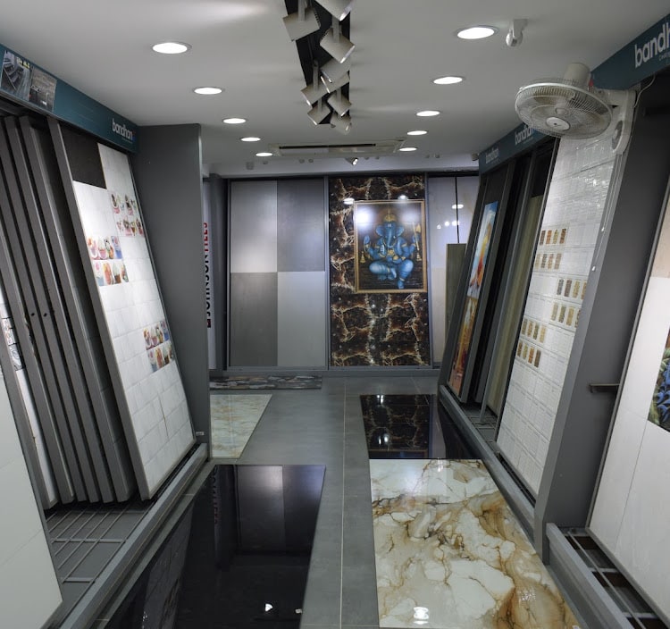 Tiles gallery aisle lined with pull-out sample panels, marble and granite floor slabs laid out between them