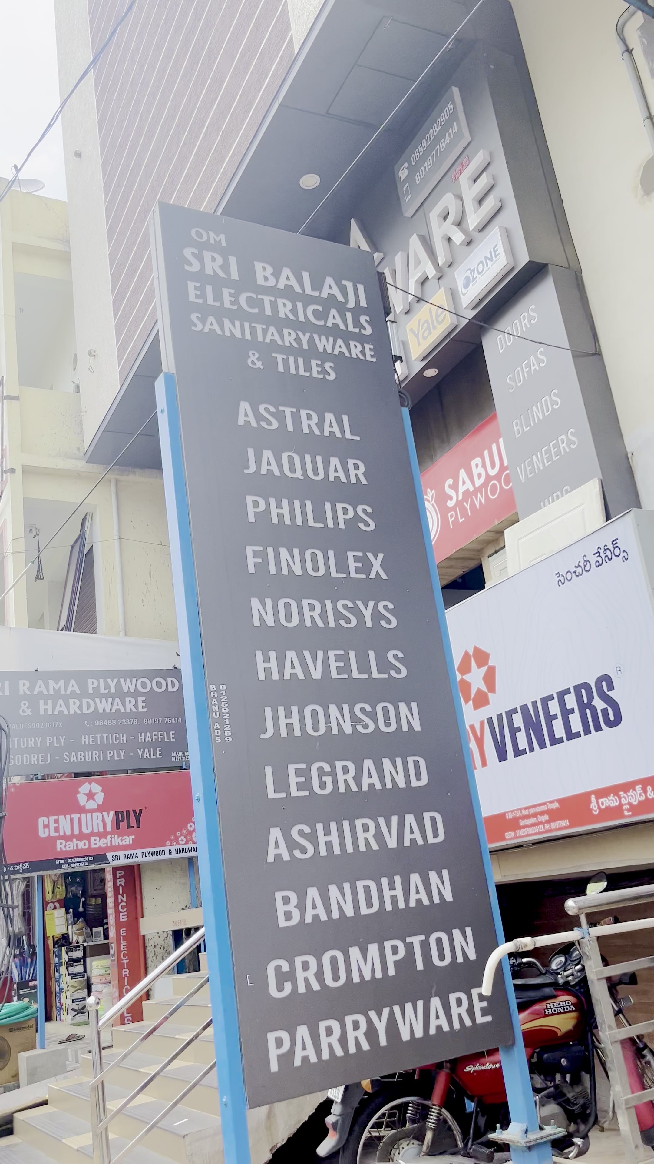 The Om Sri Balaji street signboard listing the brands stocked in store