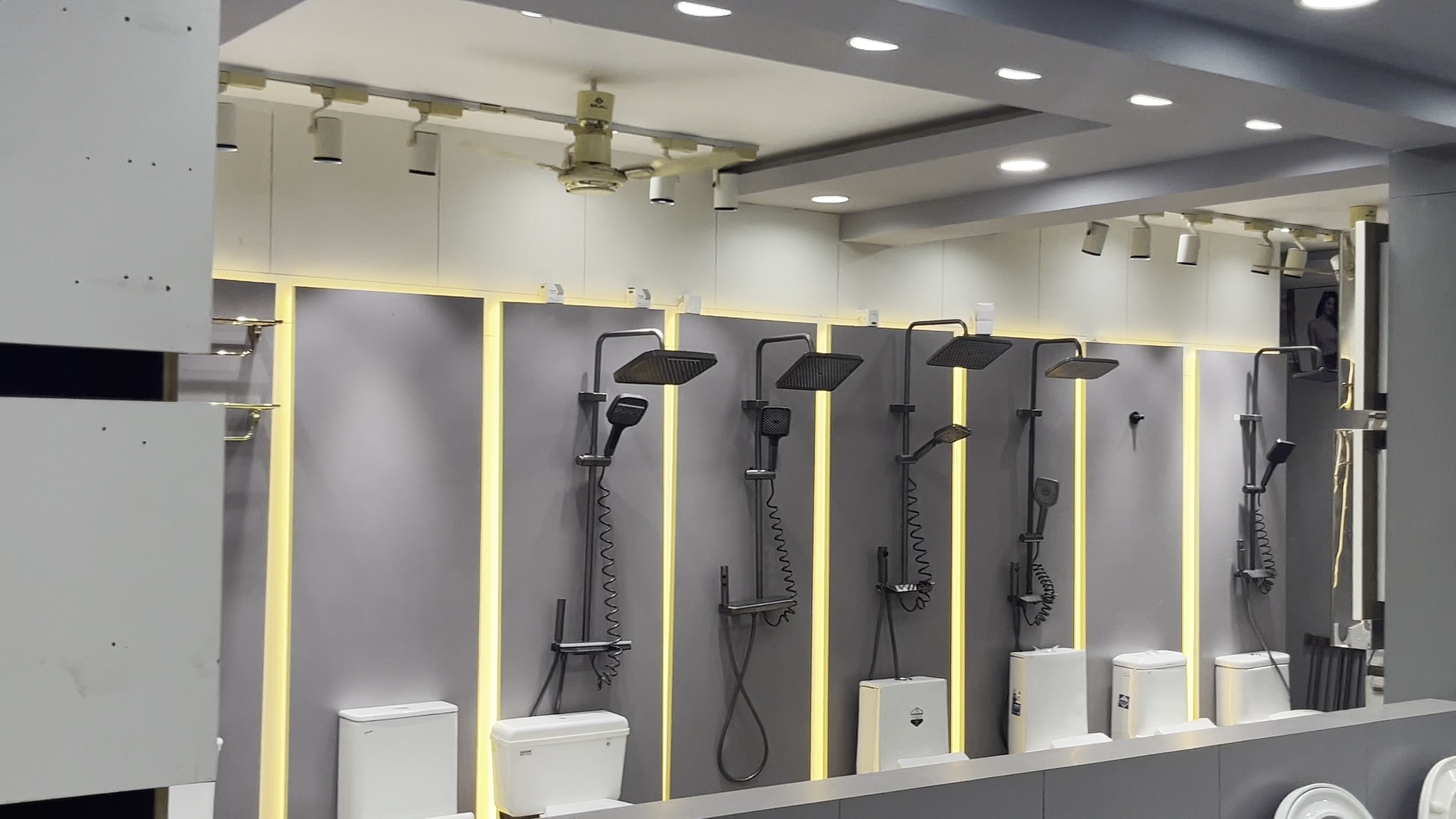 Rows of chrome showers and mixers on display panels