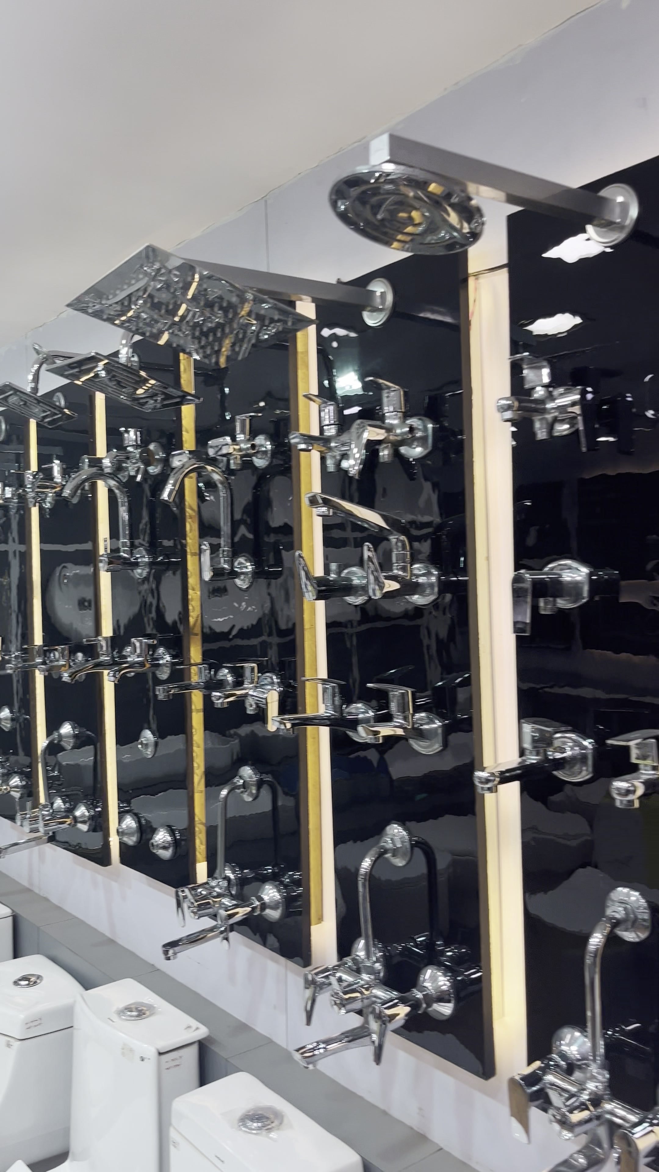 Wall-hung and floor-mounted water closets set up on the display plinth